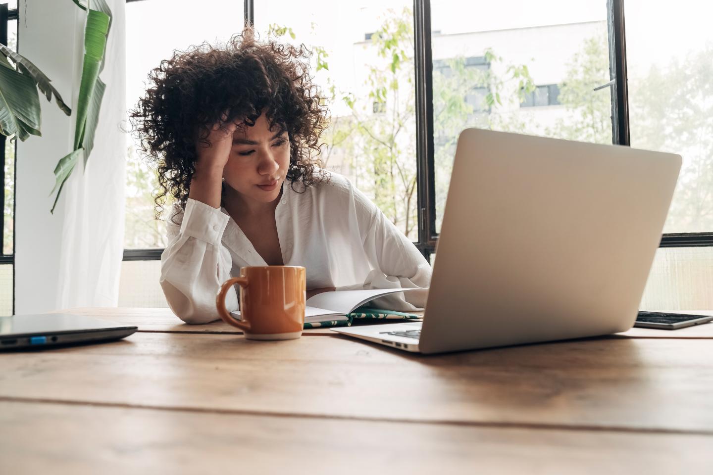 Young African American woman working on her laptop in an office.