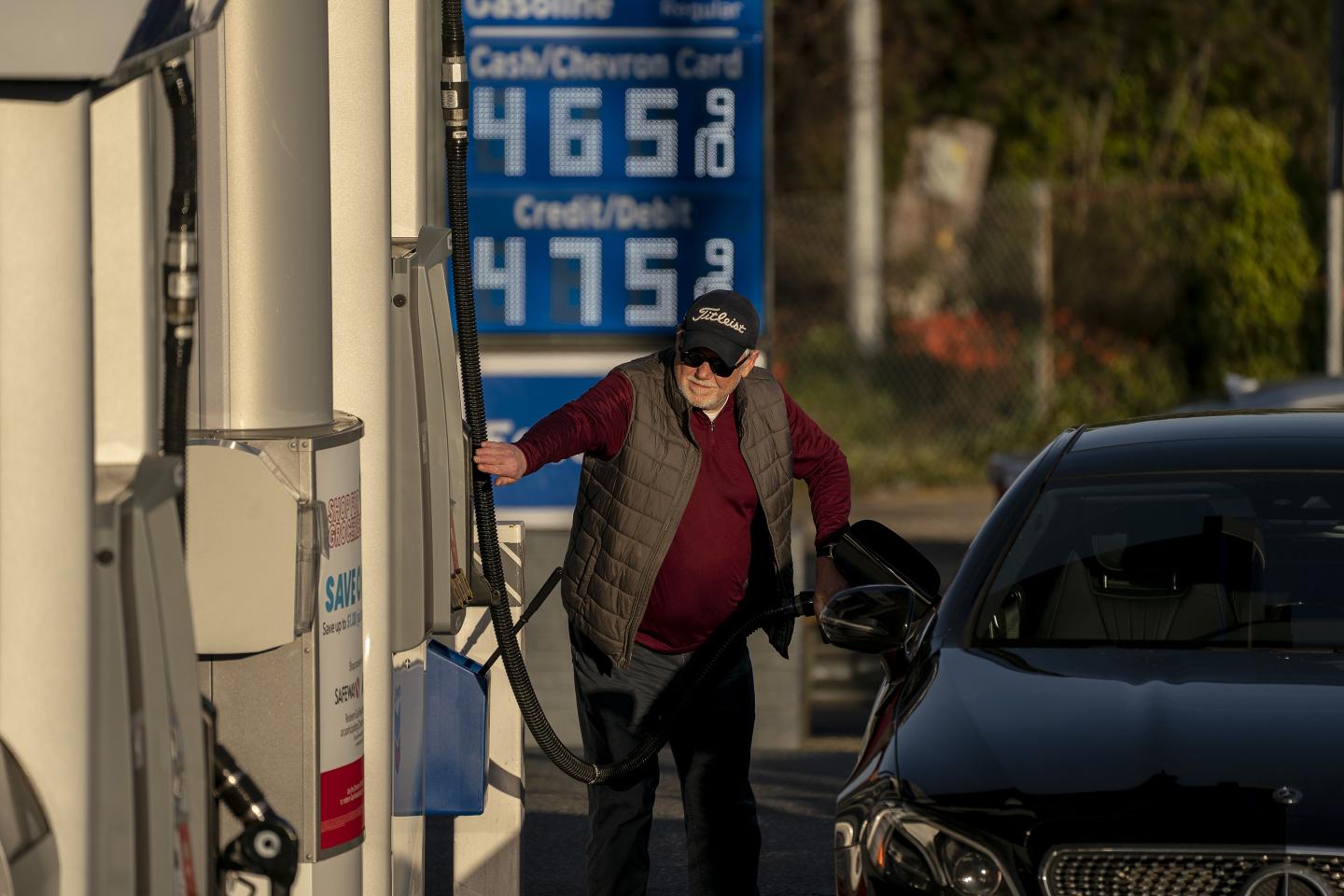 A customer refuels at a Chevron gas station with prices above $4 a gallon in Seattle.
