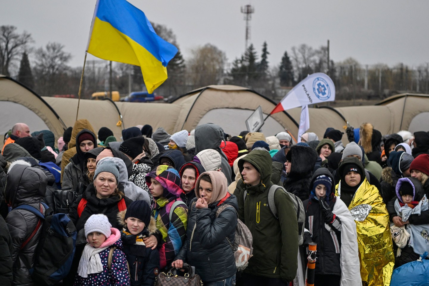 Hundreds of refugees stand in line after crossing the Ukrainian border into Poland.