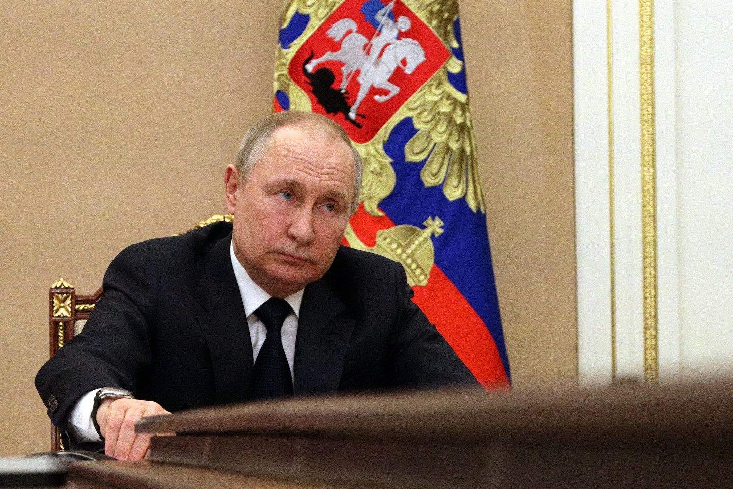 Russian President Vladimir Putin sits during a meeting.