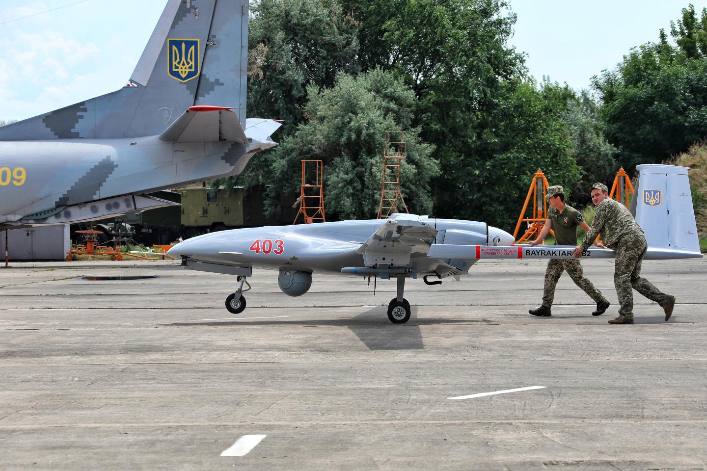 Soldiers push a Bayraktar TB2 in Ukraine.