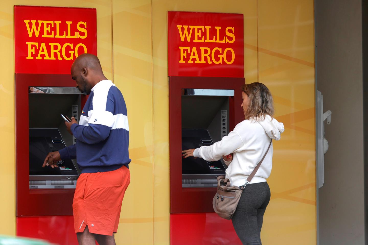 Wells Fargo customers use ATMs outside of a Wells Fargo bank on July 14, 2021 in San Francisco, California.