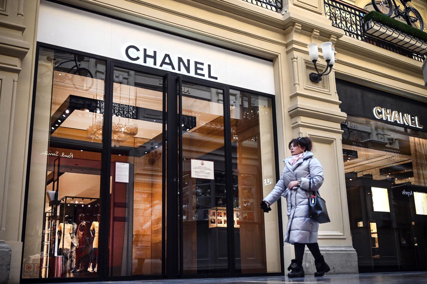 A woman walks past a closed Chanel shop in Moscow on March 10, 2022.