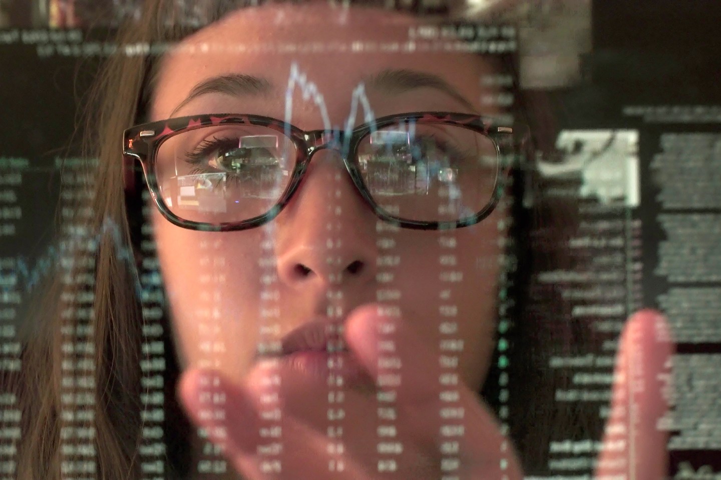 Woman's face behind touch screen display.