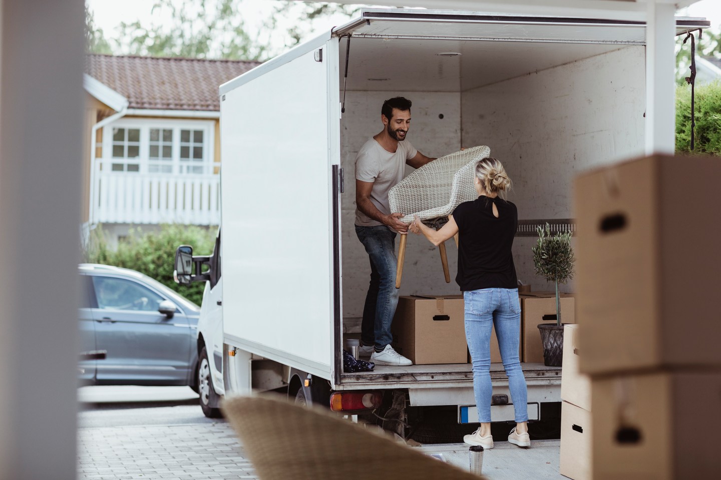 Couple Unpacking Truck To Move into New House-