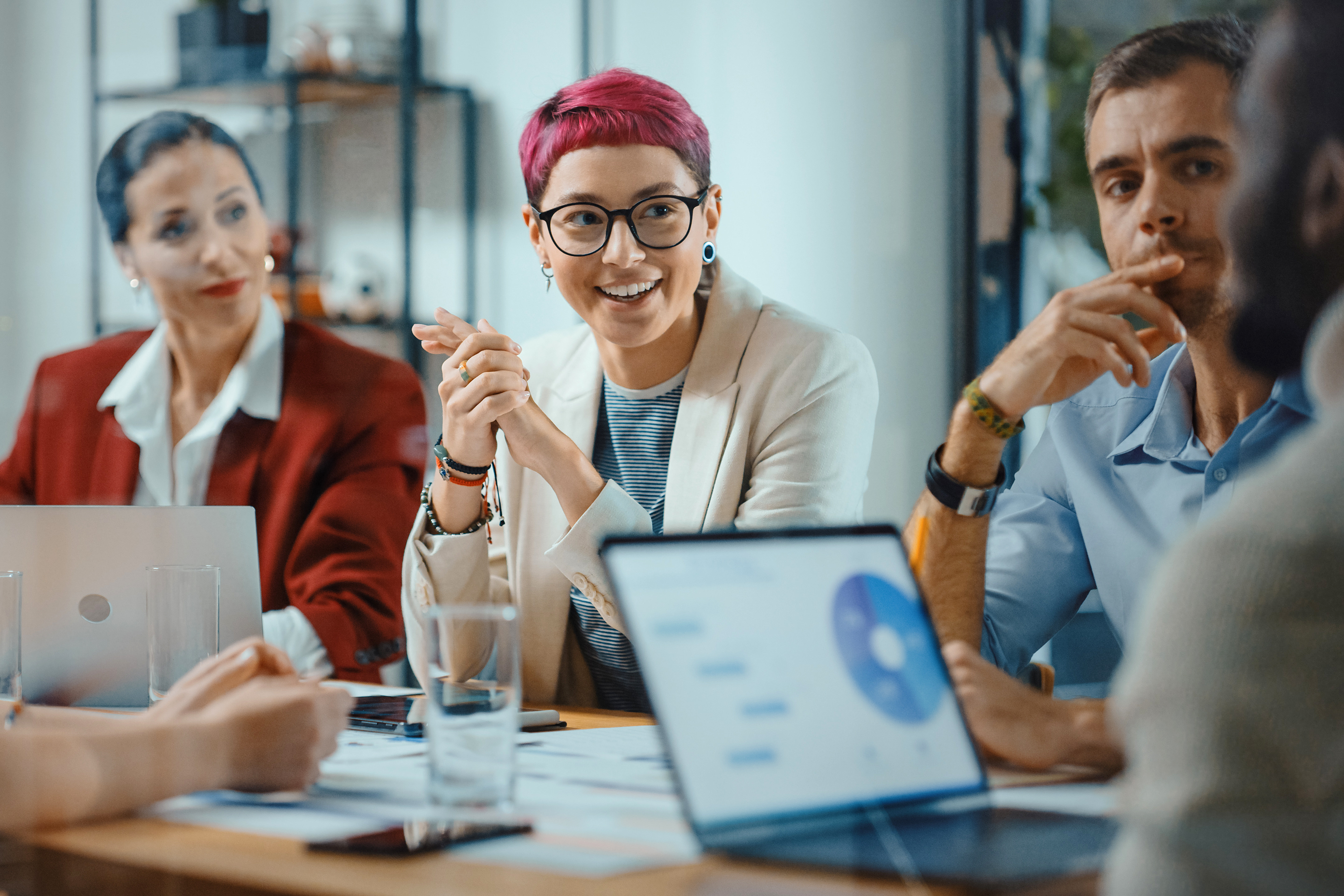 Gen Z woman in a meeting with older employees.
