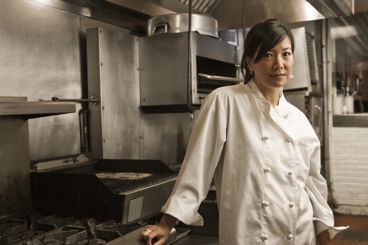 Chinese-American woman chef standing in commercial a kitchen