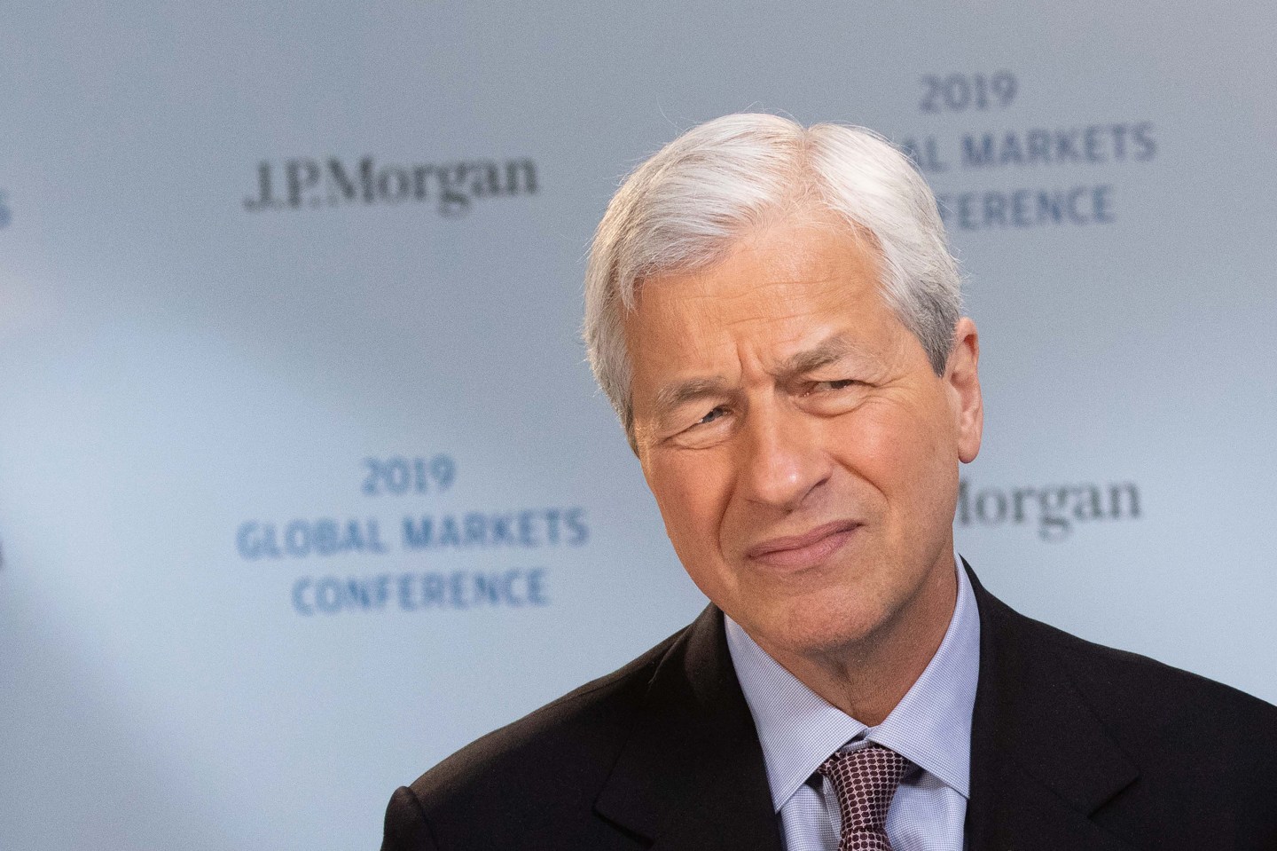 Jamie Dimon, chief executive officer of JPMorgan Chase &amp; Co., reacts during a Bloomberg Television interview at the JPMorgan Global Markets Conference in Paris, France, on Thursday, March 14, 2019.