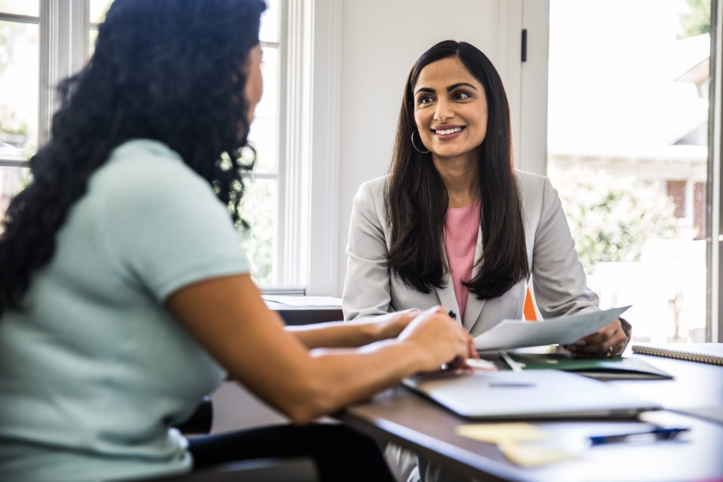 Two women meet in business office