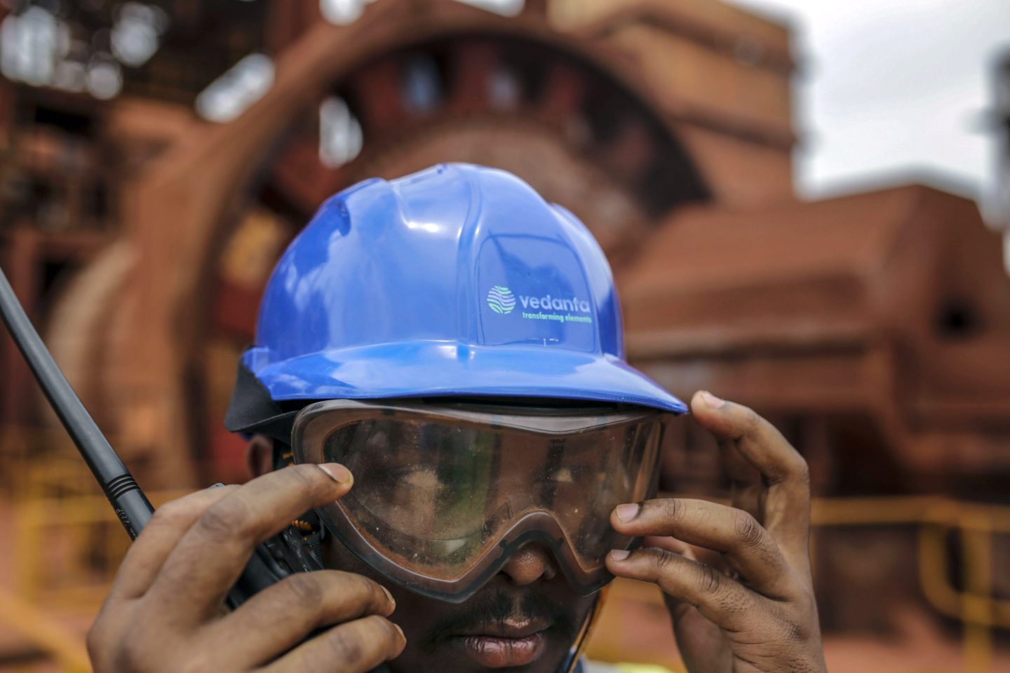 An employee fixes his goggles outside a ball mill at the Vedanta Ltd. Alumina Refinery in Lanjigarh district, Odisha, India