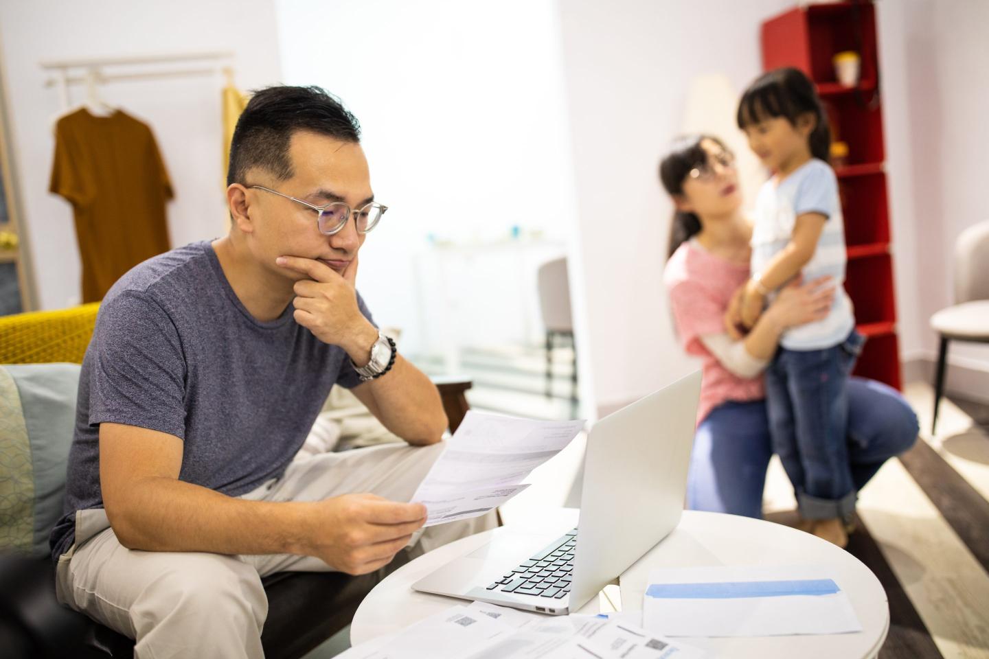 Worried man calculating bills