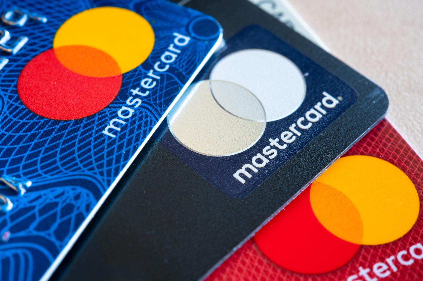 In this photo illustration there are three Mastercard Credit Cards. The branding and marketing logo of a financial company. Business related conceptual image.