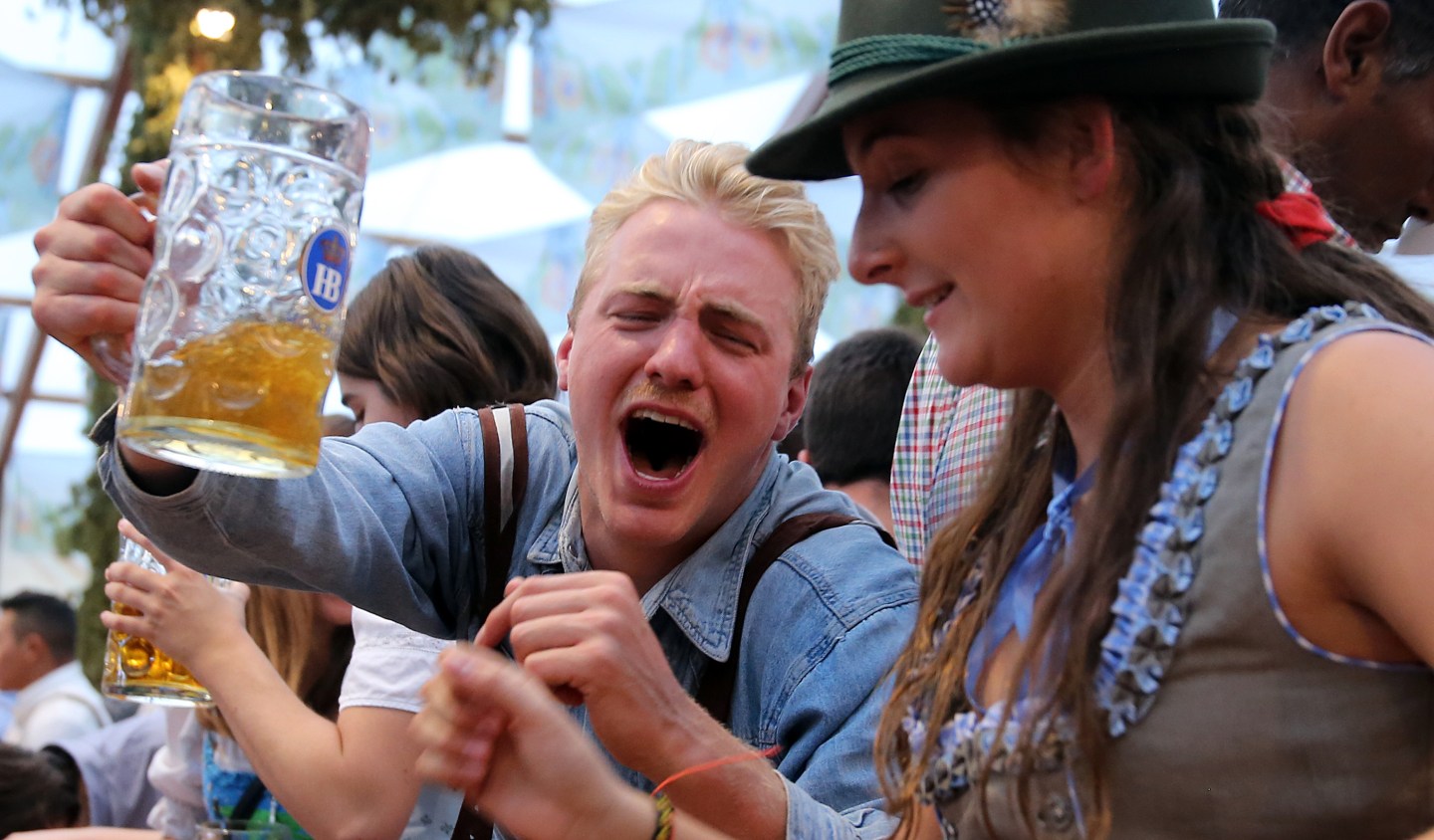 Revelers cheer with 1-liter-mugs of beer during the opening weekend of the 2019 Oktoberfest.