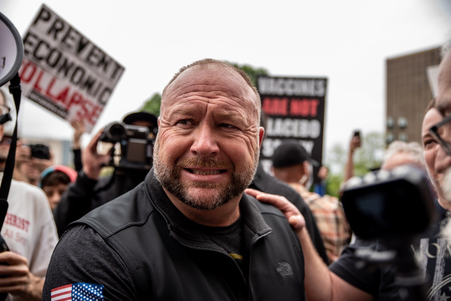 Infowars founder Alex Jones interacts with supporters at the Texas State Capital building on April 18, 2020, in Austin, Texas. The protest was organized by Infowars host Owen Shroyer who is joining other protesters across the country in taking to the streets to call for the country to be opened up despite the risk of the COVID-19.