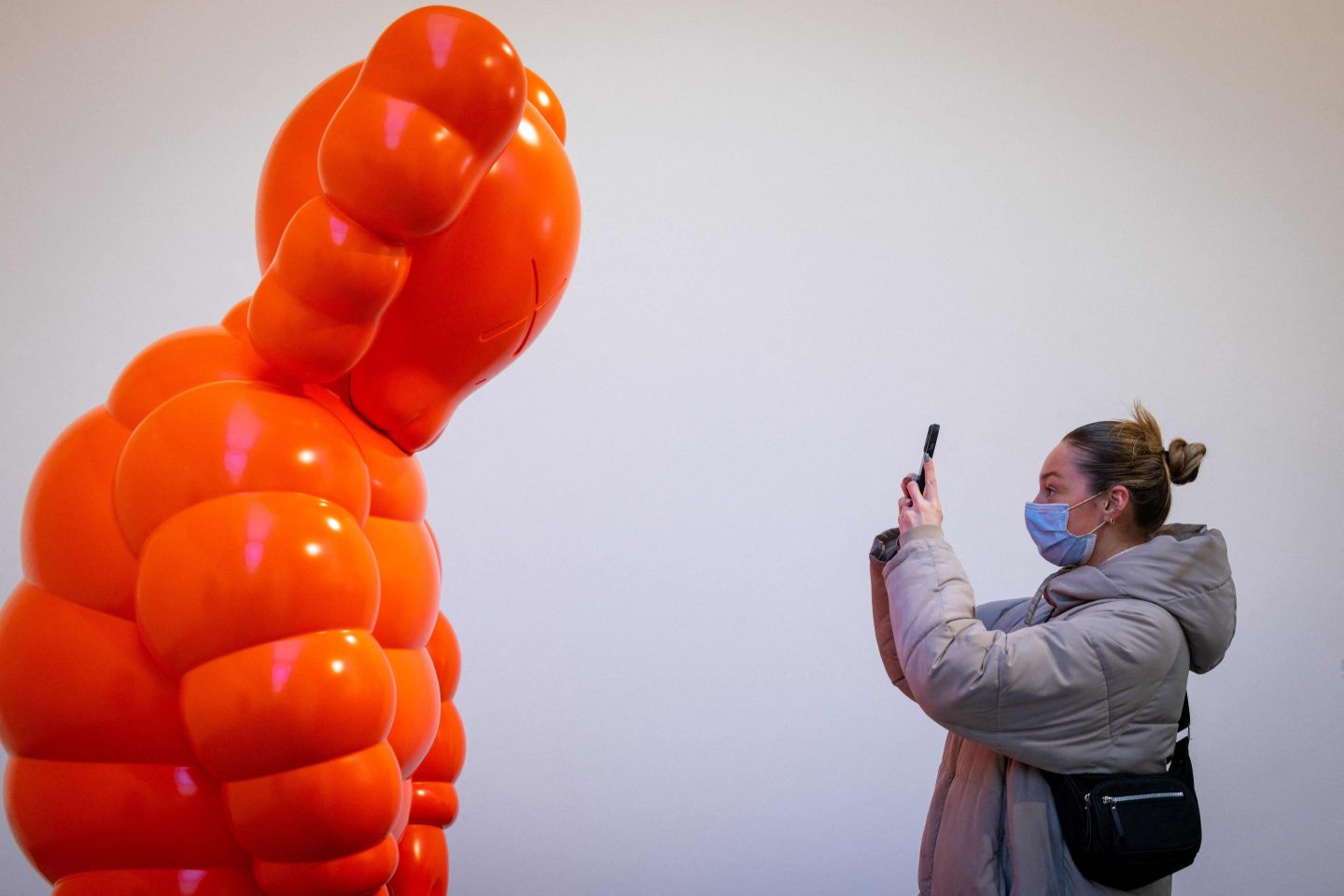 A visitor at the multi-platform exhibition of work by U.S. artist KAWS at London's Serpentine Gallery in January 2022.