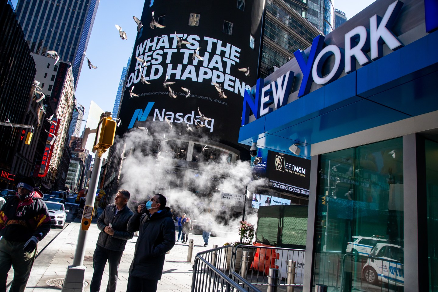 Pedestrians in front of the Nasdaq MarketSite in Times Square, New York City