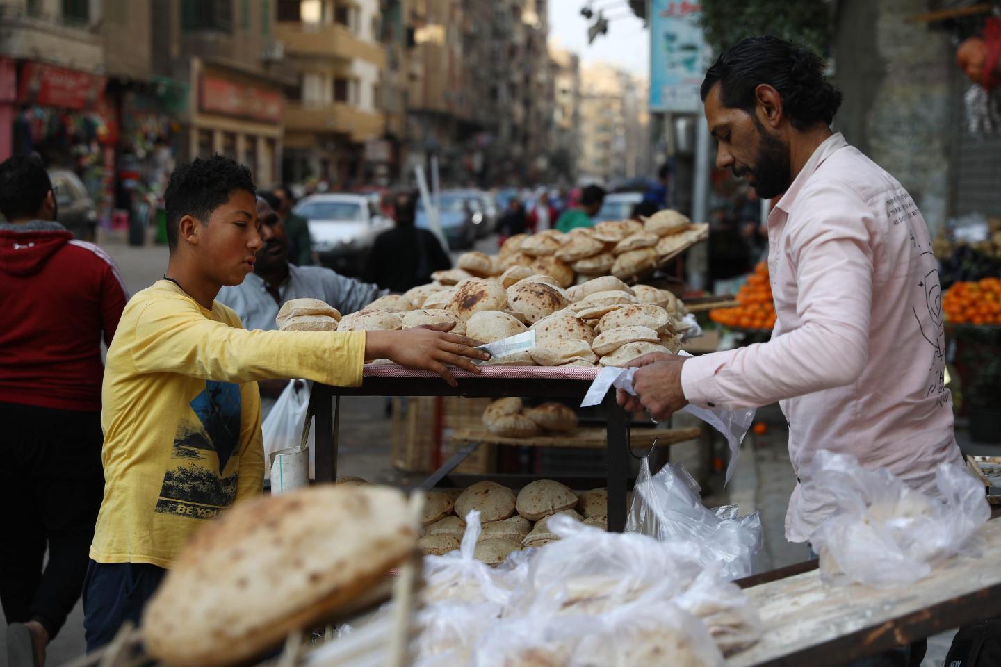 A boy buys bread at a market in Cairo, Egypt, on March 9, 2022.