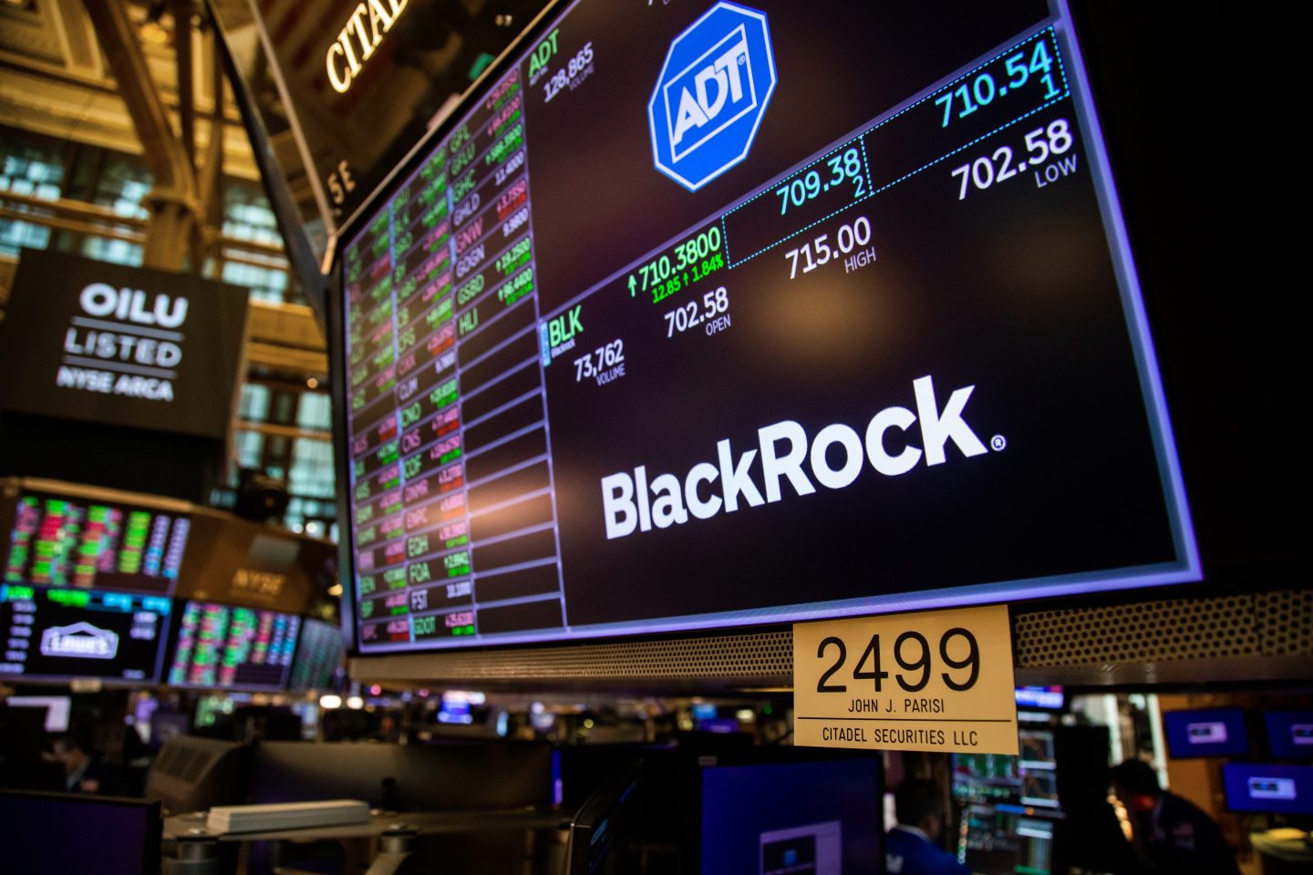 A monitor with Blackrock Inc. signage on the floor of the New York Stock Exchange