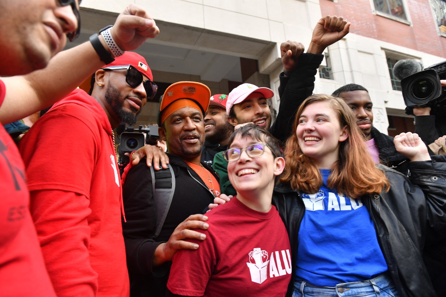 Union organizer Christian Smalls (L) celebrates following the April 1, 2022, vote for the unionization of the Amazon Staten Island warehouse in New York.