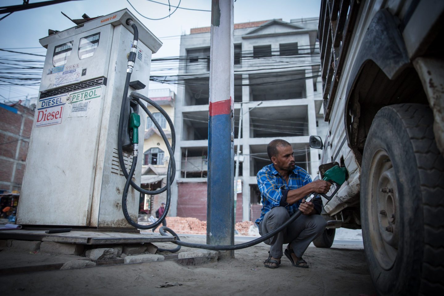 A man refuels his car in Nepal