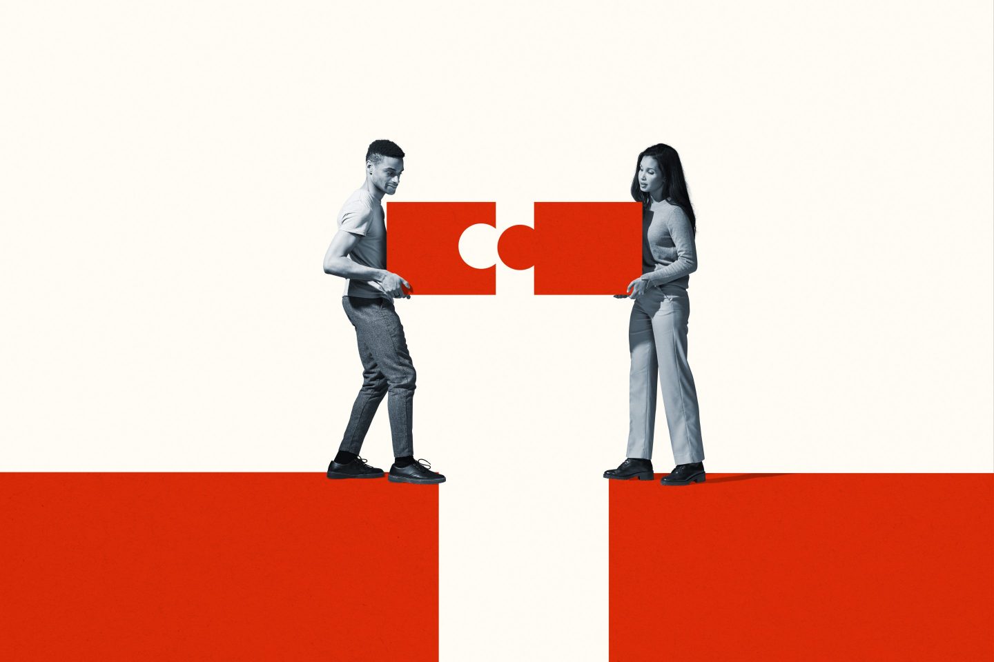 A man and a woman work together to position puzzle pieces