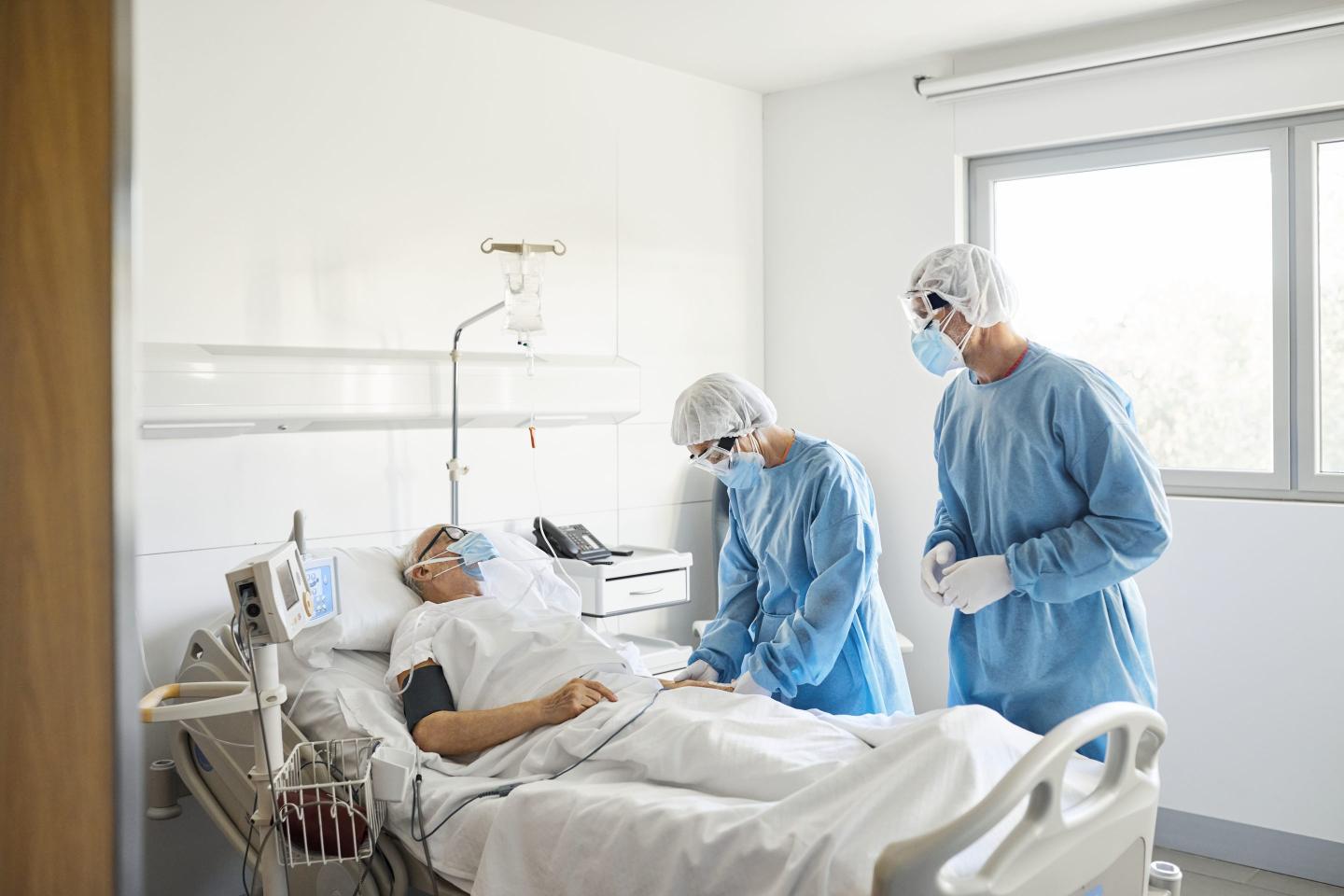 Doctors examining a patient during COVID pandemic