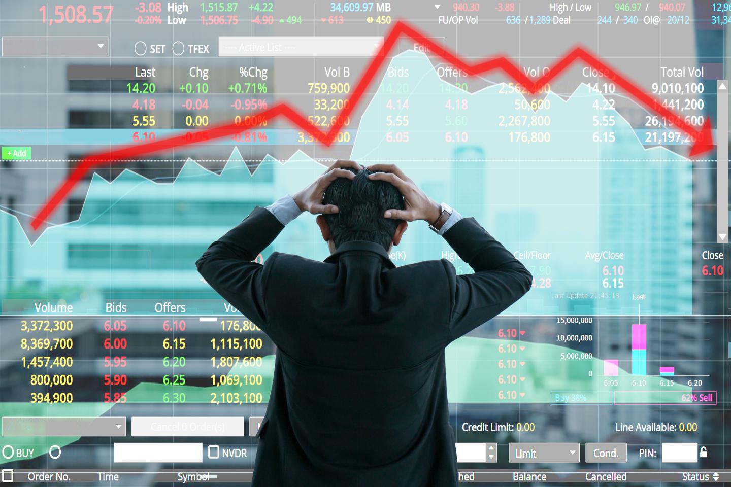 Businessman grabs head with business chart on scoreboard