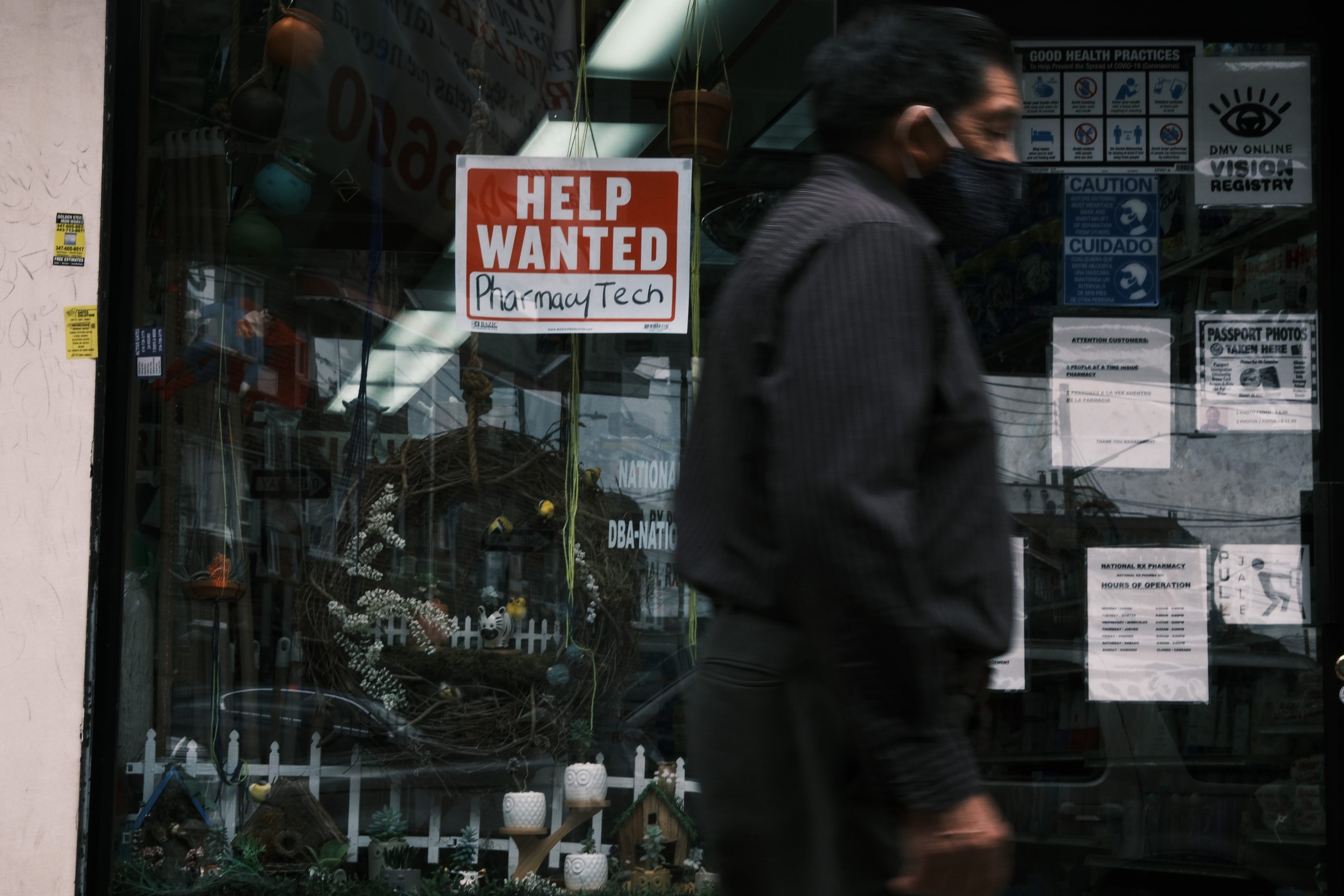 Man walks past help wanted sign in New York City