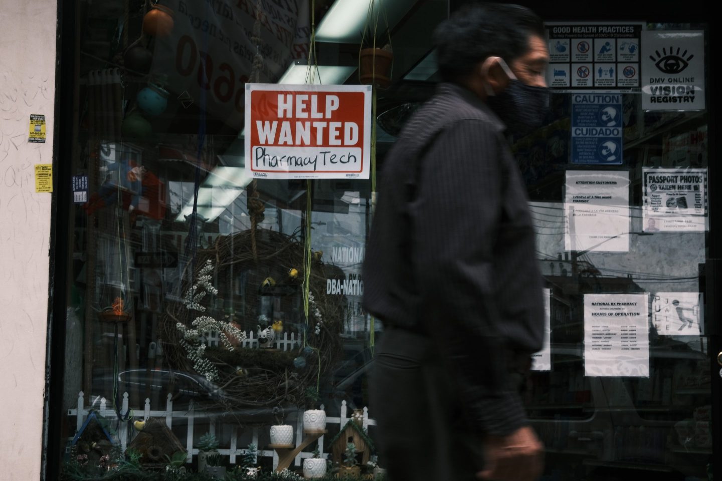Man walks past help wanted sign in New York City