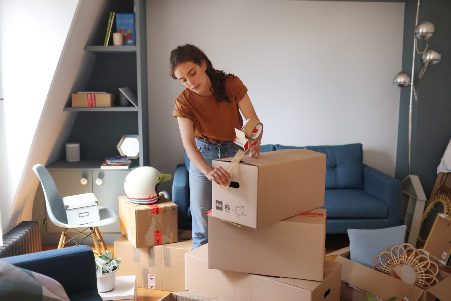 A young woman is packing her moving boxes