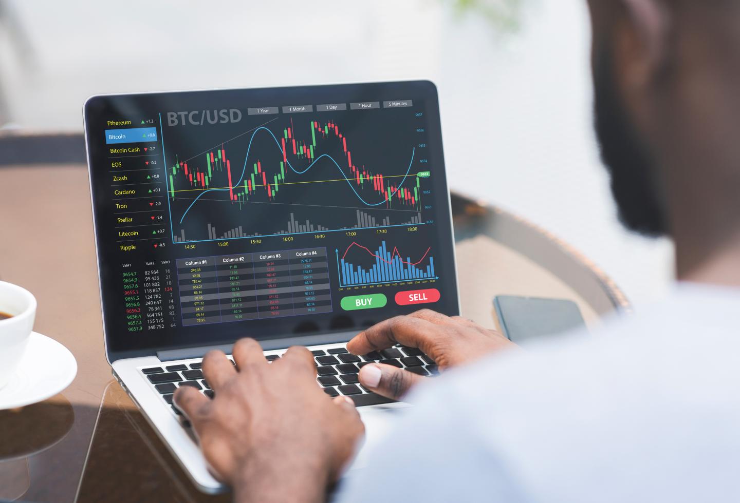 Cropped of black businessman analysing market online while working in office, using website for analysis on laptop, copy space. Business analysis, online trading on stock and markets concept