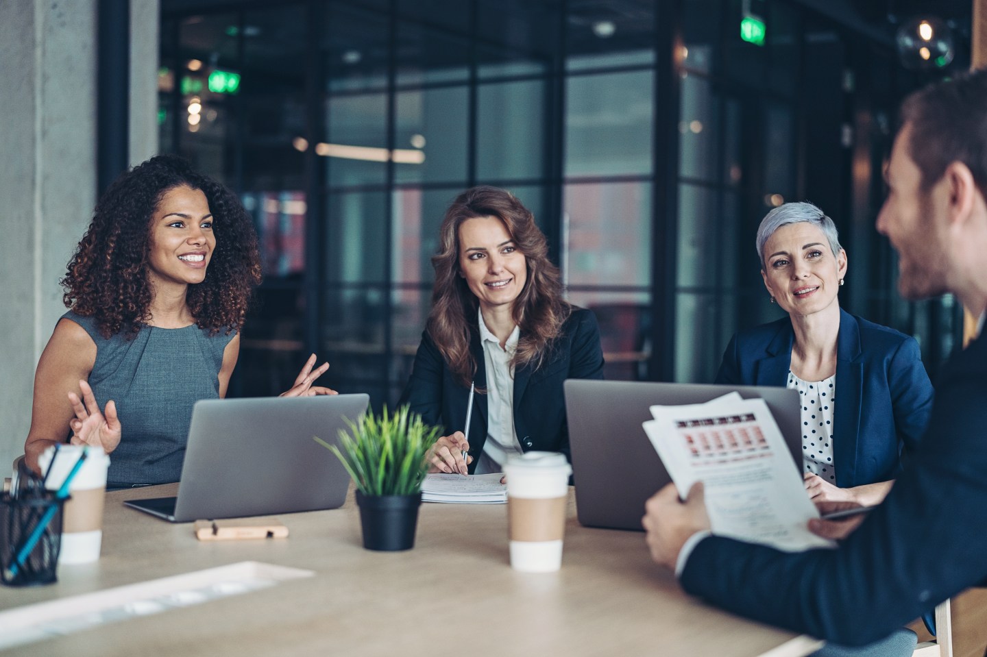 Group of business persons sitting around a table and talking