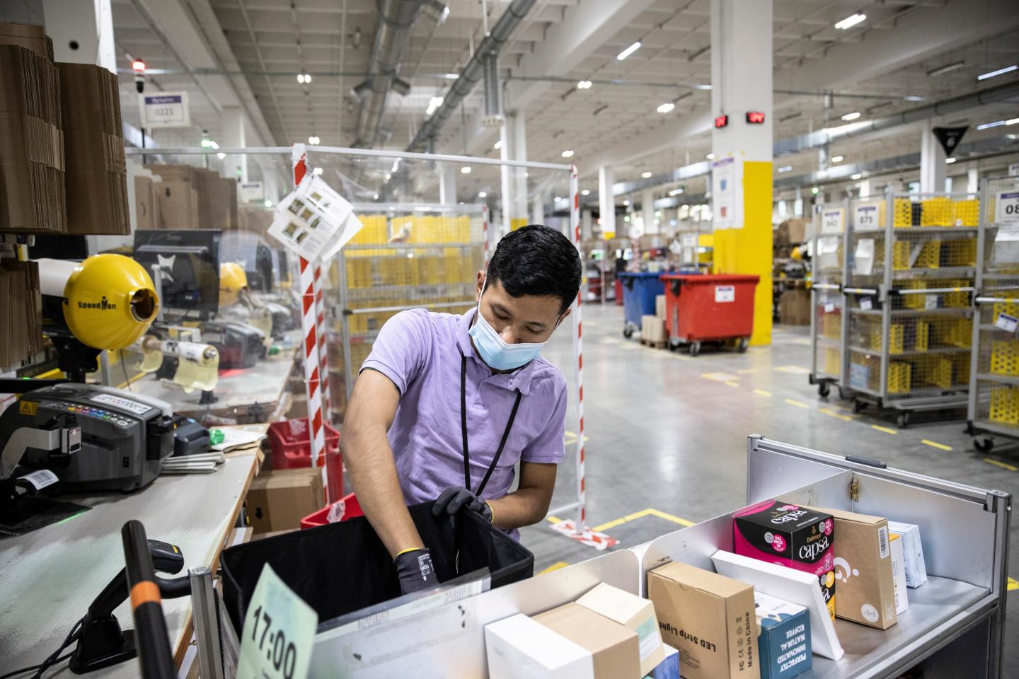 An Amazon worker packs items.
