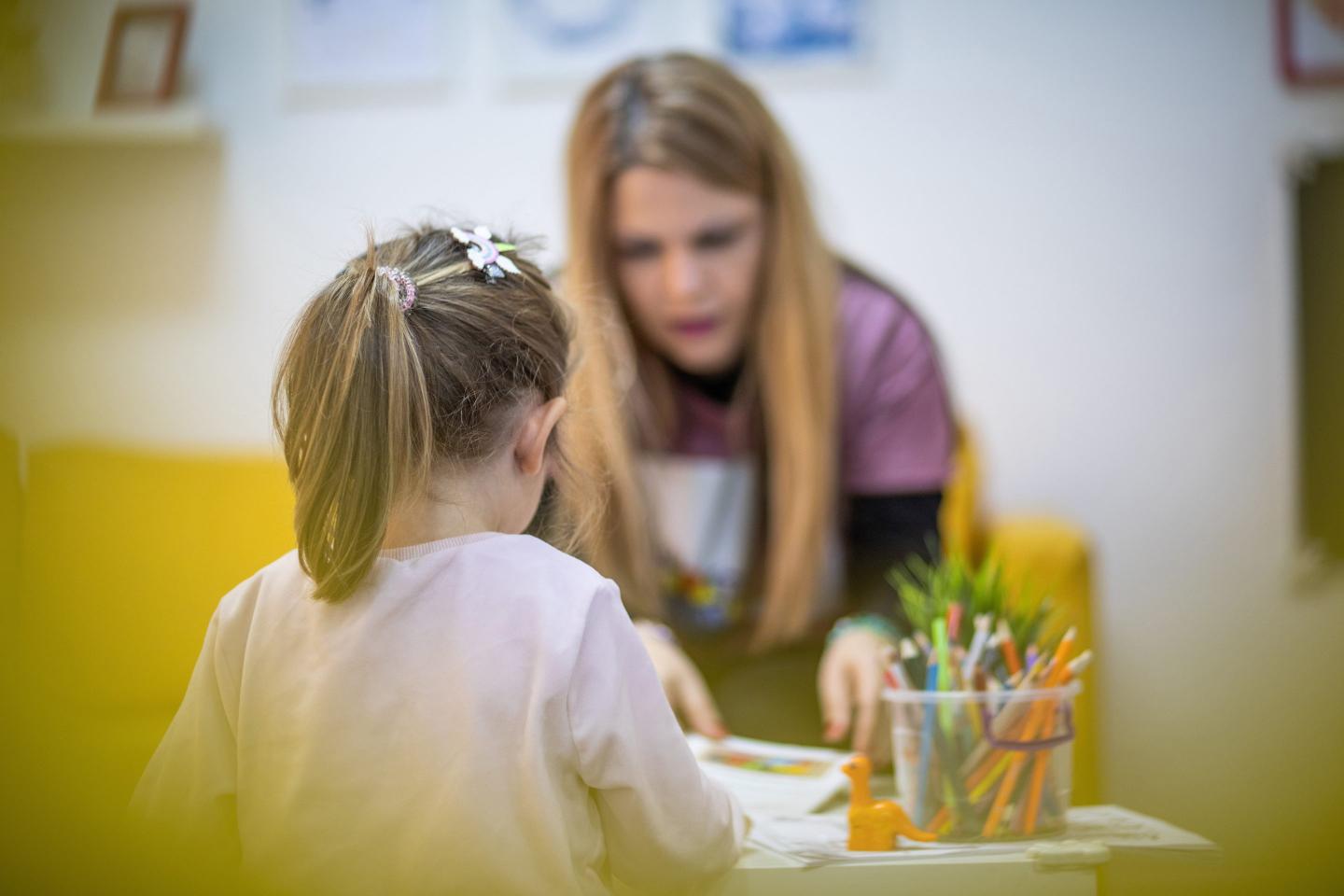 Daycare teacher with child