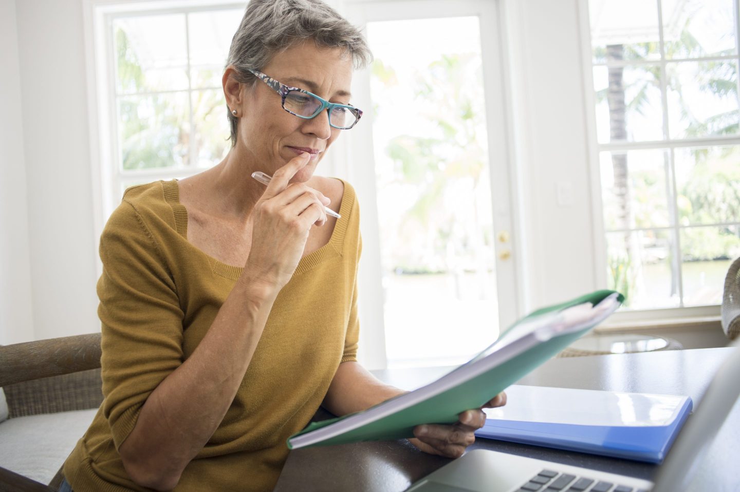 Older woman looks through financial documents