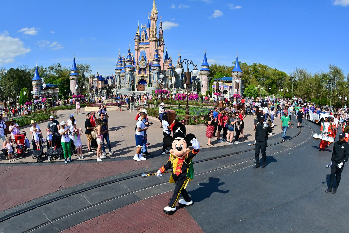 Mickey Mouse waves to fans during a parade at Walt Disney World Resort.