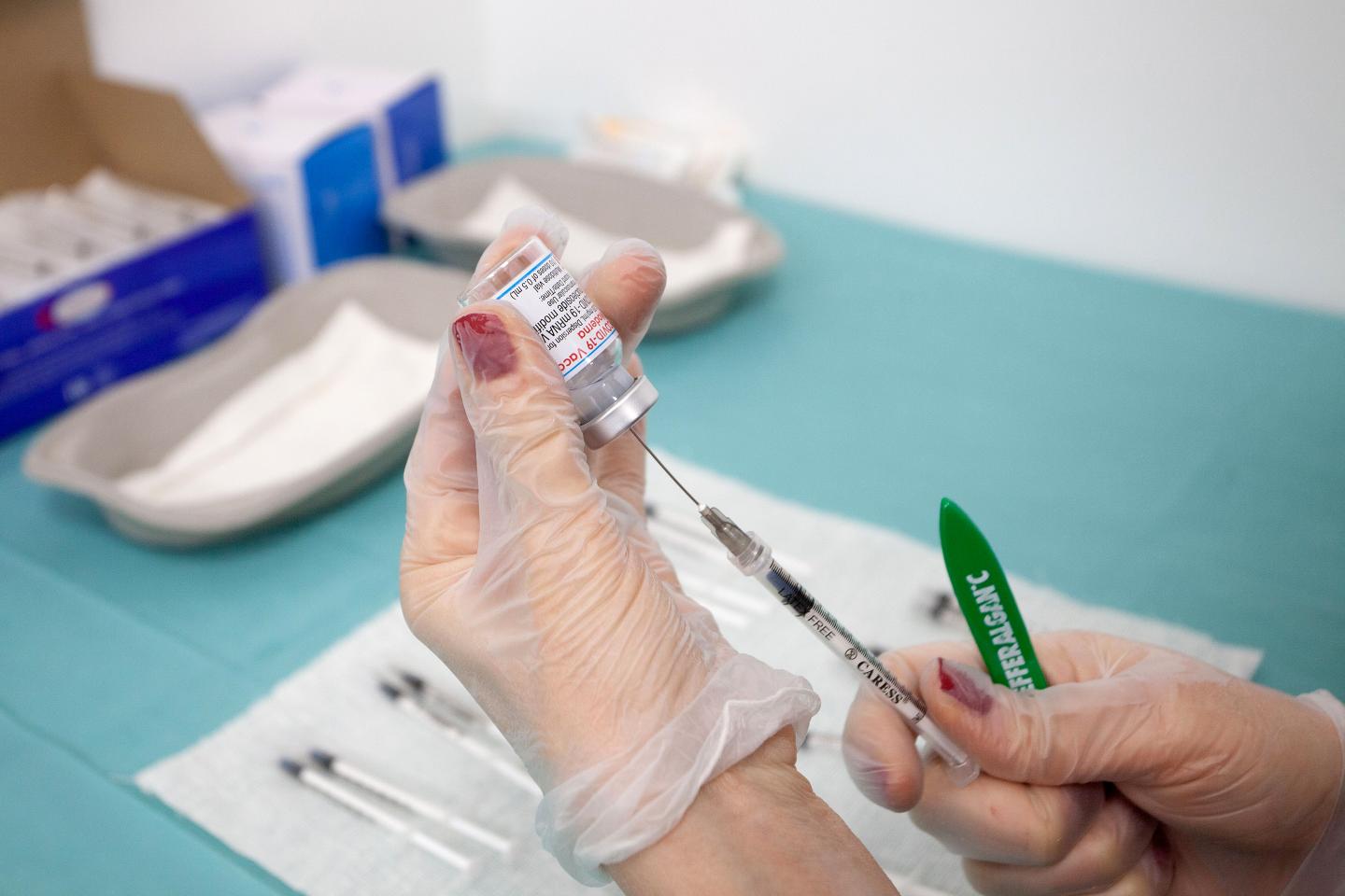 A nurse prepares syringes with the Moderna covid 19 vaccine in Bari, Italy.