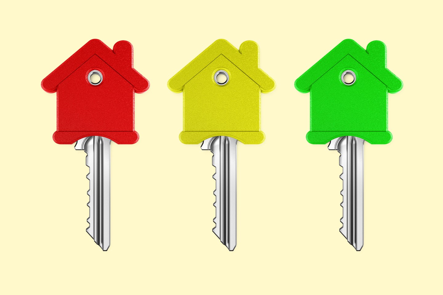 A phot illustration of three keys with houses on top of them.