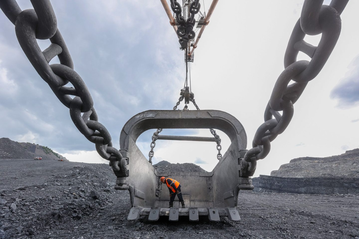 A coal worker inspects a giant crane bucket at a Russian coal mine.
