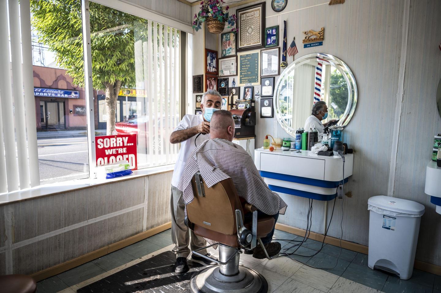 A man gets a haircut in a small business.