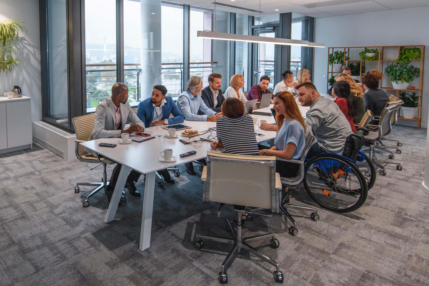 Executive Team Sitting at Conference Table in Board Room