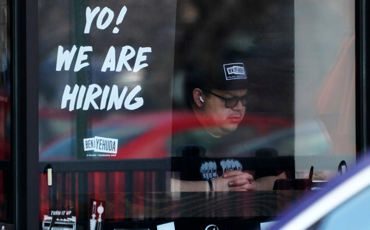 A hiring sign on a business.