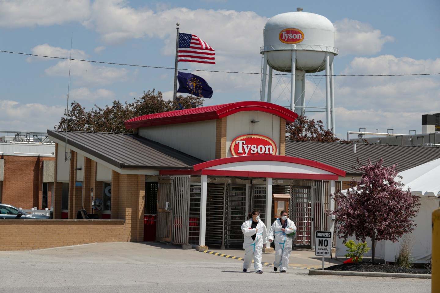 In this May 7, 2020 file photo, workers leave the Tyson Foods pork processing plant in Logansport, Ind. At the height of the pandemic, the meat processing industry worked closely with political appointees in the Trump administration to stave off health restrictions and keep processing plants open even as COVID-19 spread rapidly among workers, according to a new Congressional report released Thursday, May 12.