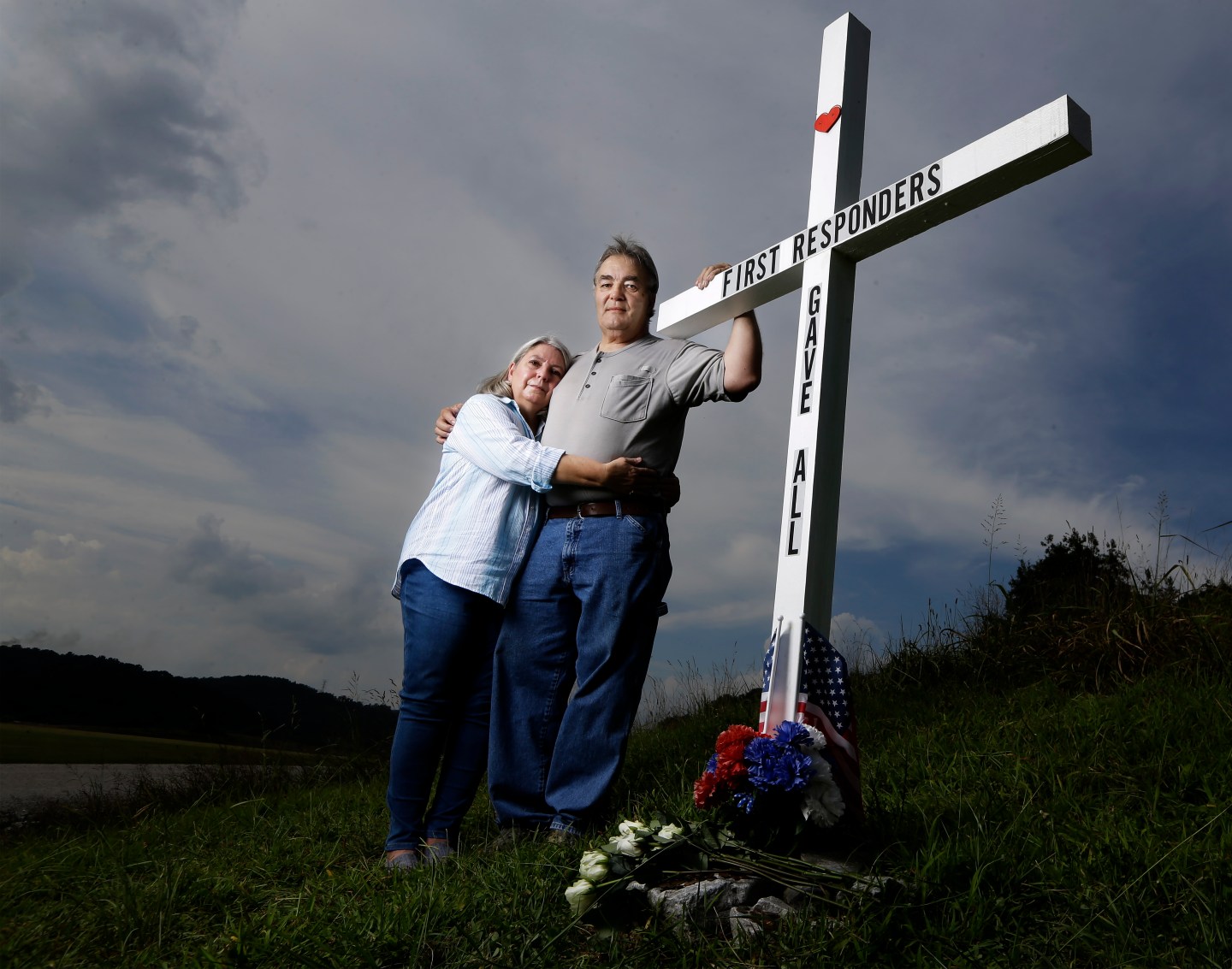 In this Aug. 6, 2019, photo, Ansol and Janie Clark pose at a memorial Ansol Clark constructed near the Kingston Fossil Plant in Kingston, Tenn. The Tennessee Valley Authority was responsible for a massive coal ash spill at the plant in 2008 that covered a community and fouled rivers. The couple says the memorial is for the workers who have come down with illnesses, some fatal, including cancers of the lung, brain, blood and skin and chronic obstructive pulmonary disease. Ansol Clark who drove a fuel truck for four years at the cleanup site, and suffered from a rare blood cancer, has also died now.