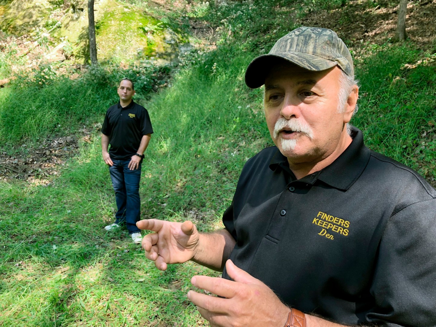Dennis Parada, right, and his son Kem Parada stand at the site of the FBI's dig for Civil War-era gold in September 2018, in Dents Run, Pennsylvania. A scientific report commissioned by the FBI shortly before agents went digging for buried treasure suggested that a huge quantity of gold was below the surface, according to newly released government documents.