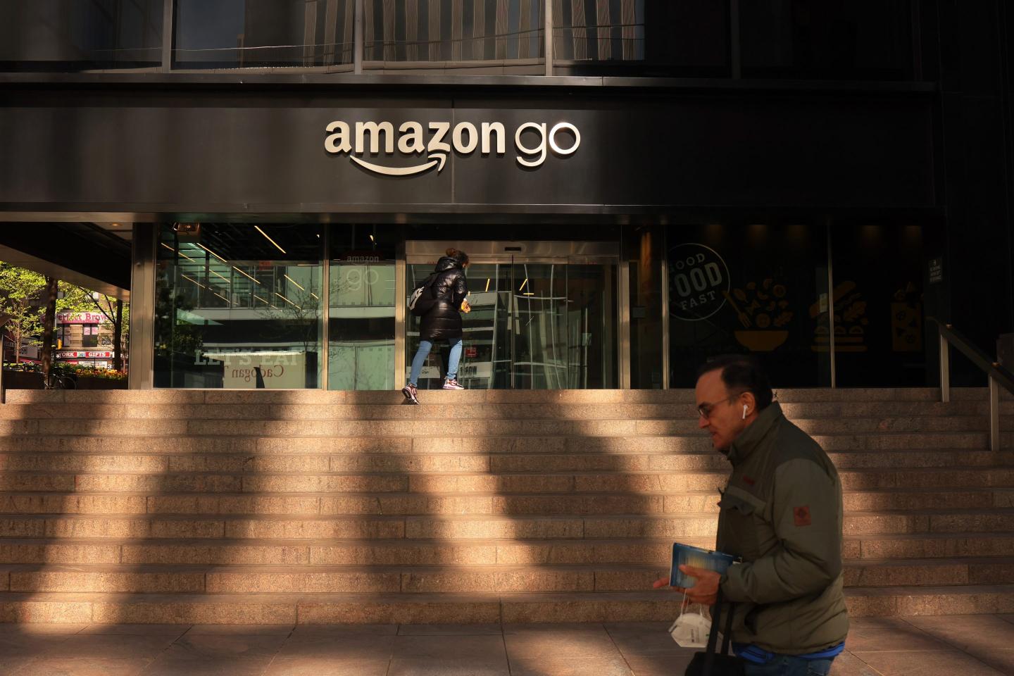 A person walks in front of an Amazon Go store.