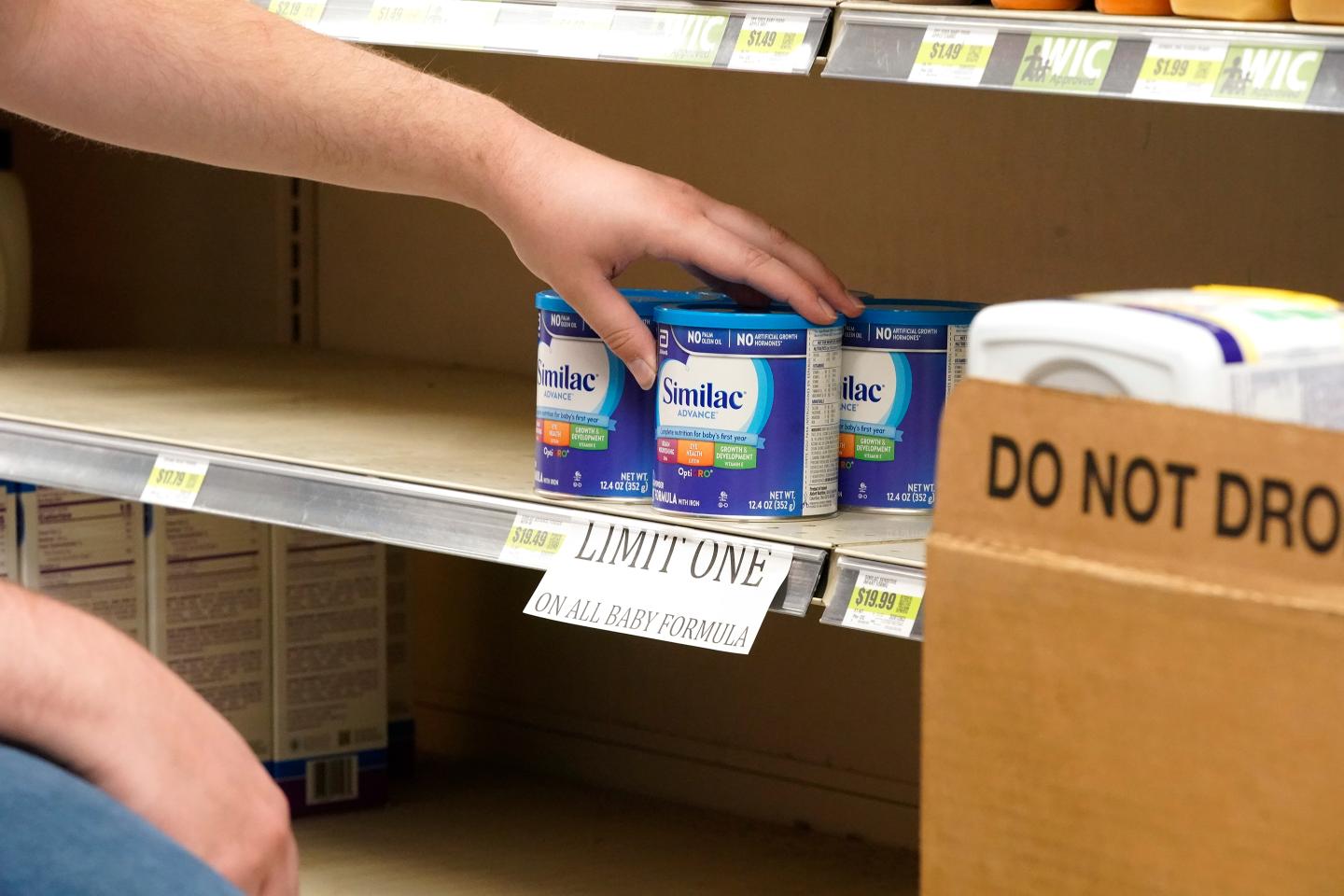 A worker restocks shelves with baby formula at a store in Provo, Utah.