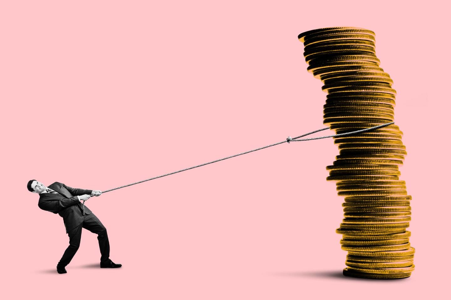 Man pulling a large stack of coins