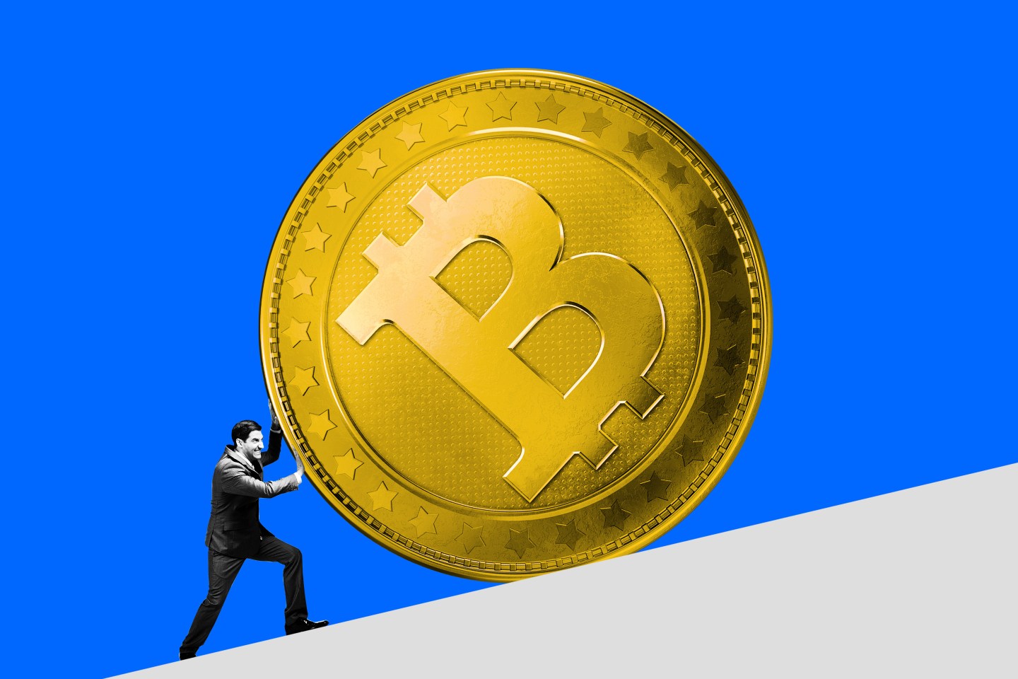 man pushing bitcoin up a hill