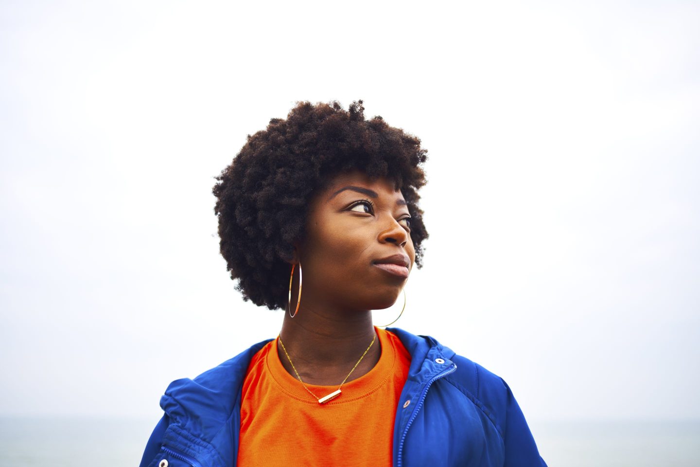 portrait of woman looking off camera with colourful clothing